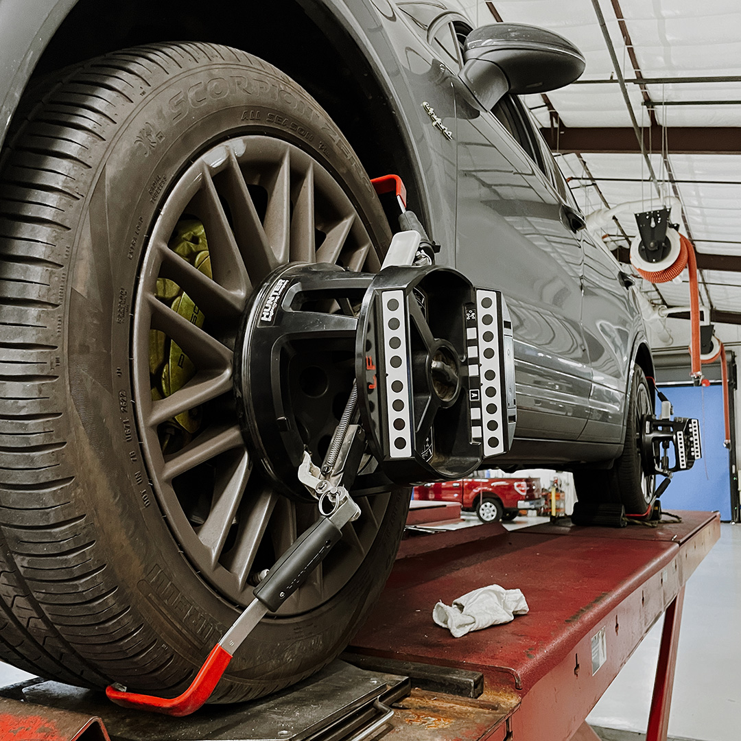 A lose-up view of a care tire going through a wheel alignment procedure 