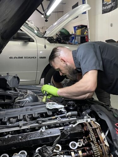 Fifth Gear Auto Repair Technician performing a car maintenance checkup including oil changes, AC checks, Tune ups, and tire inspections.