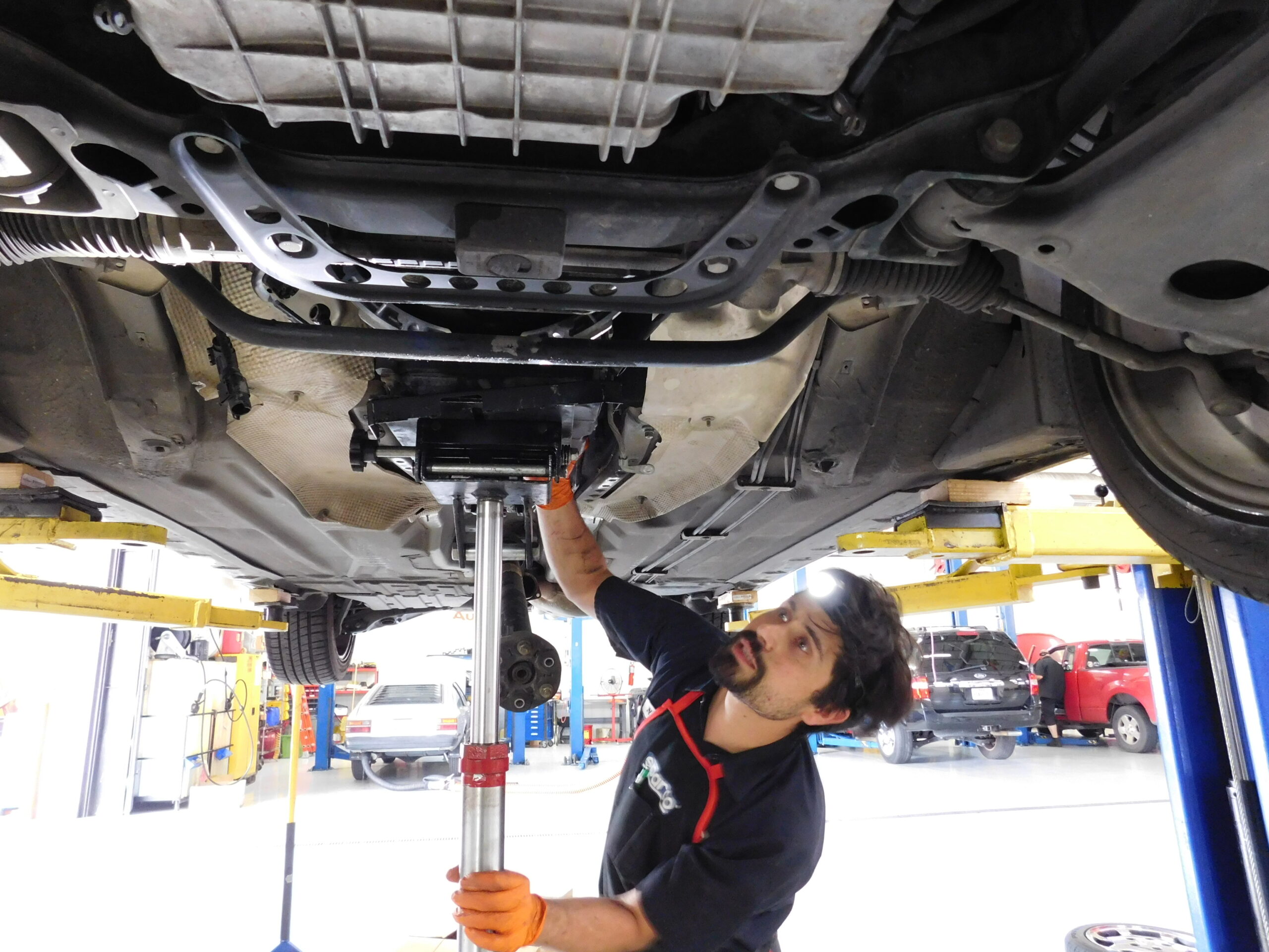 Fifth Gear auto repair technician installing a transmission 
