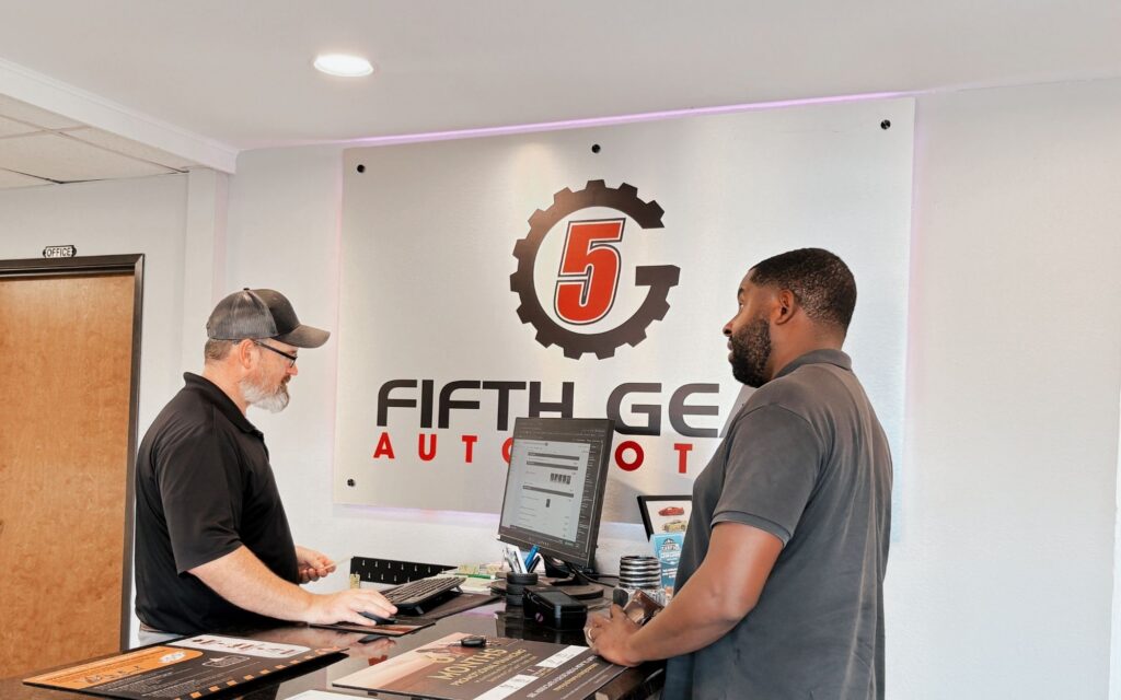 Fifth Gear Automotive Repair Shop Manager speaking with a client