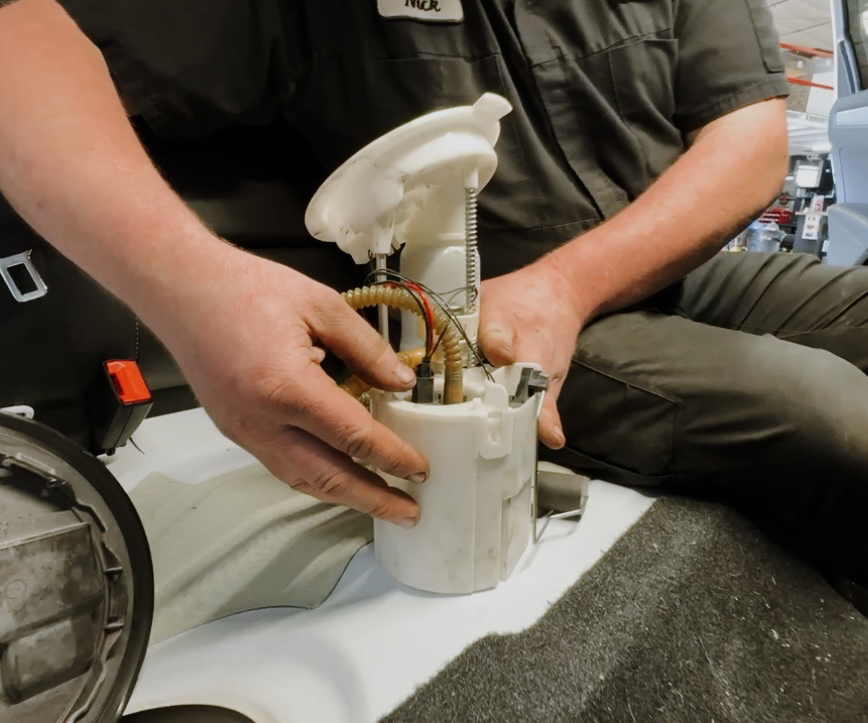 Fifth Gear technician Nick Gerelman inspecting VW fuel pump module sender unit