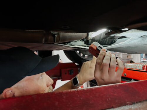 Fifth Gear Auto Repair Technician checking an auto's oil